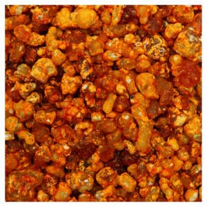 Eine Nahaufnahme eines Haufens orangefarbener und brauner Steine mit dem Duft von Weihrauch-Zitronenblüte.